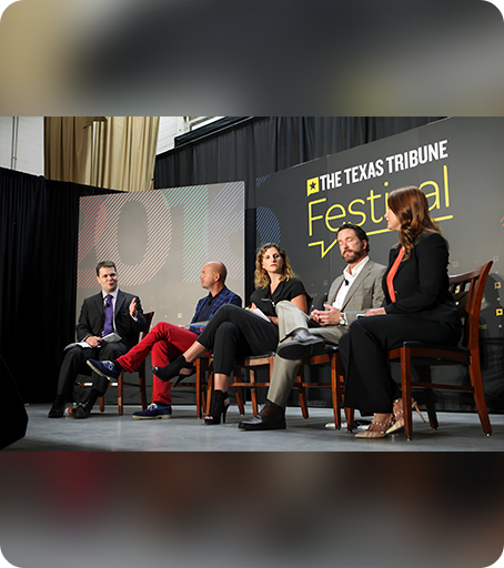 A group of people sitting on chairs in front of an audience.