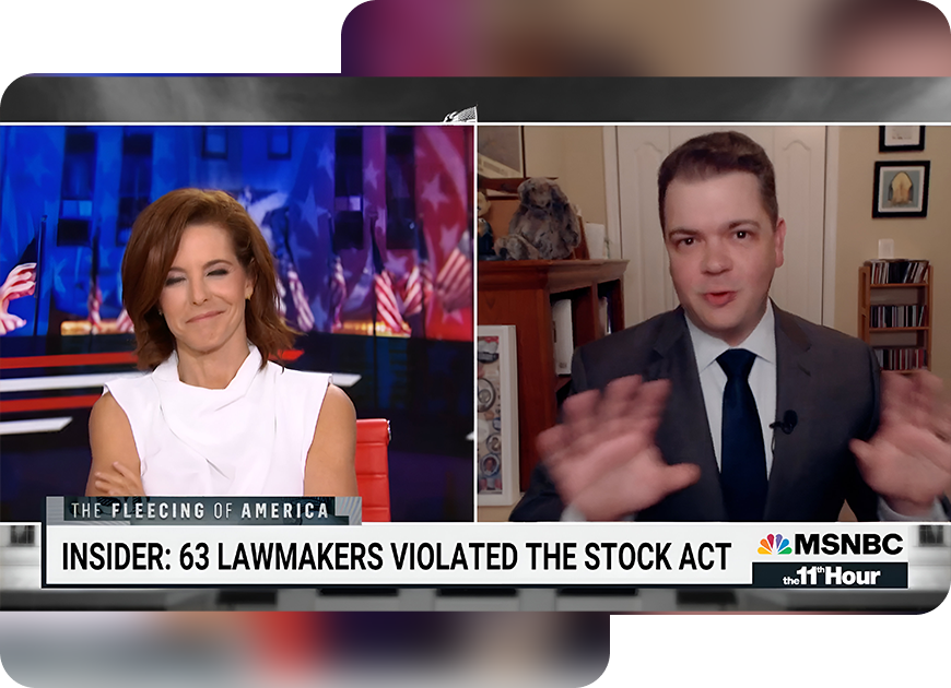 A man and woman sitting in front of an msnbc screen.